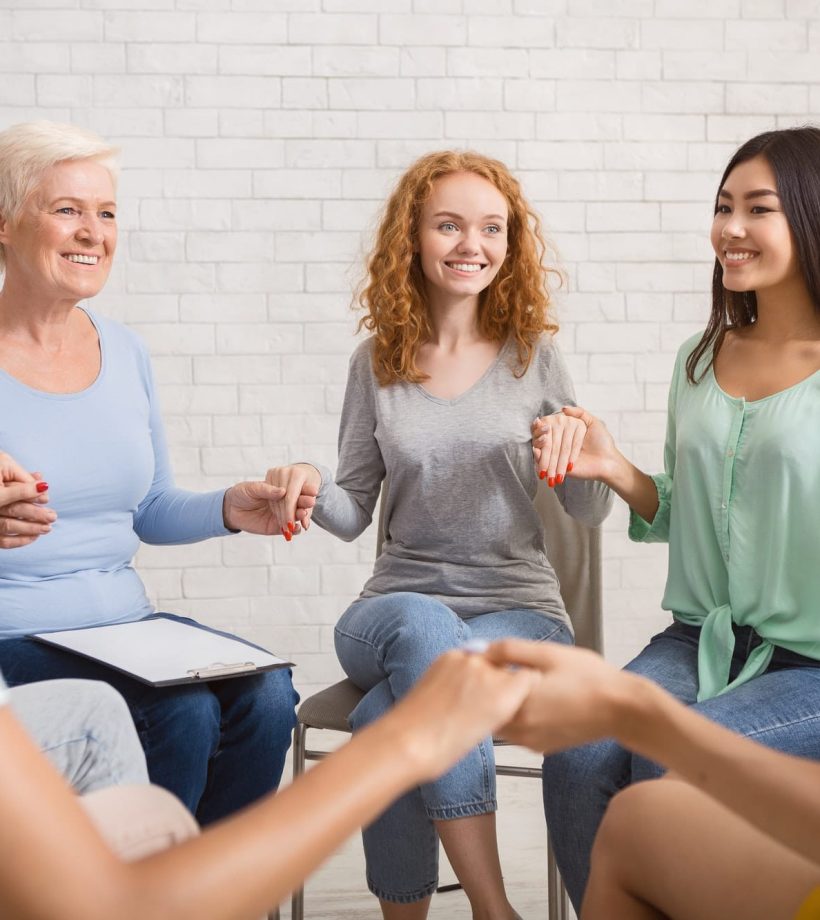 smiling-diverse-women-sitting-in-circle-during-group-therapy-indoor.jpg smiling-diverse-women-sitting-in-circle-during-group-therapy-indoor.jpg